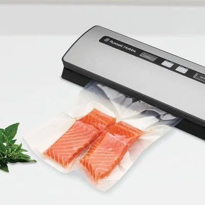 An external sealer sealing a bag containing two salmon fillets