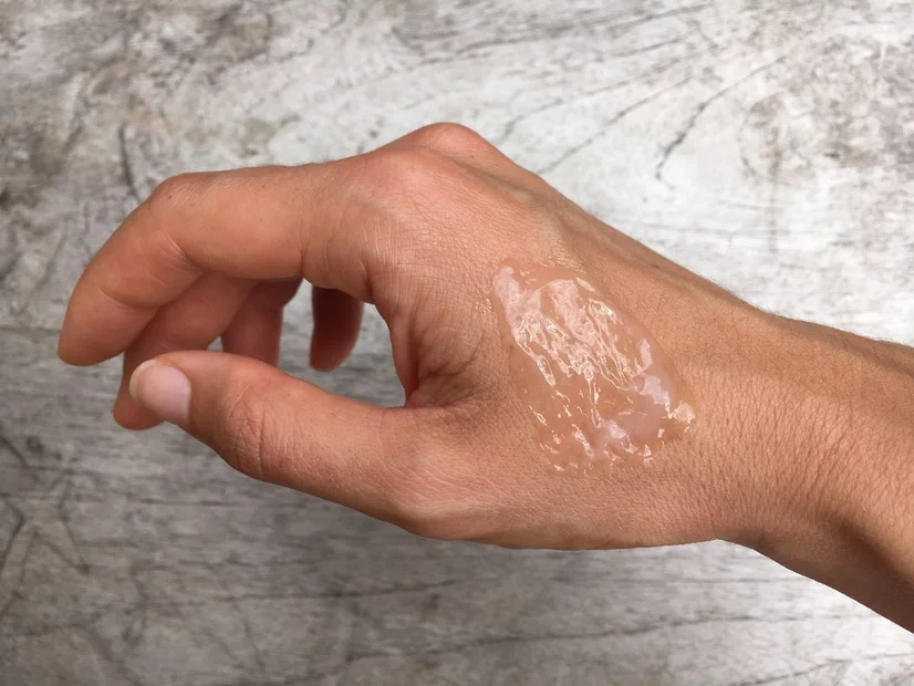 A swatch of the Clinique Moisture Surge 100H applied onto the hand of the reviewer.