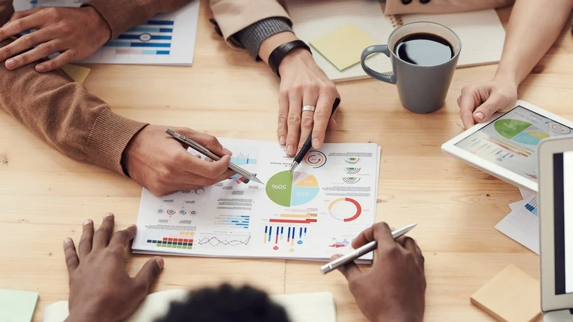 Some people sitting around a table creating a financial plan.