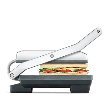 A sandwich with cheese tomato ham and lettuce in Breville Toast and Melt appliance