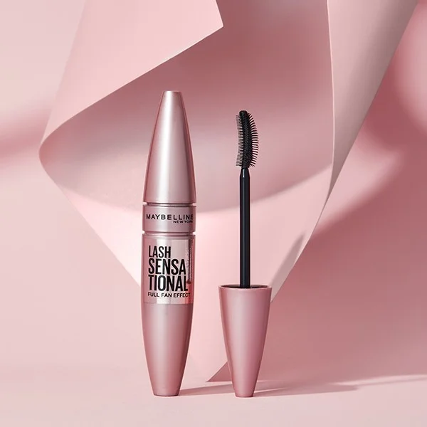 The Maybelline Lash Sensational Mascara against a pink background.