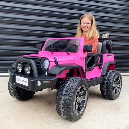 smiling girl in toy car
