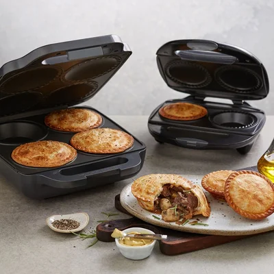 pie makers with cooked mushroom and meat pies