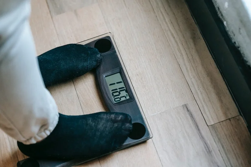 Someone standing on a digital bathroom scale.
