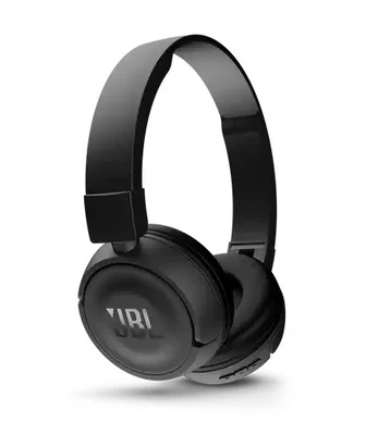 a smiling man wearing a pair of jbl tune 450T headphones