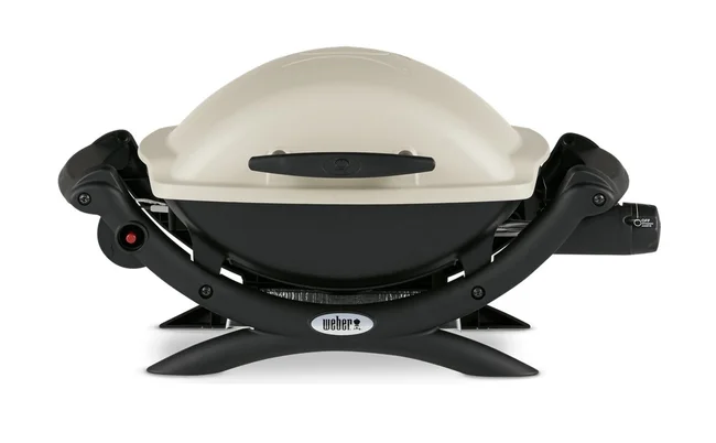 An ivory and black Weber Baby Q barbecue.