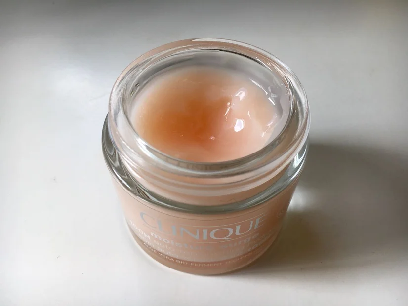 An open container of Clinique's Moisture Surge 100H. Some of the product has been used.