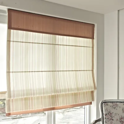 Beige Roman blinds in a lounge room.