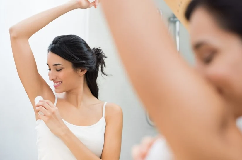 Woman applying a roll-on deodorant