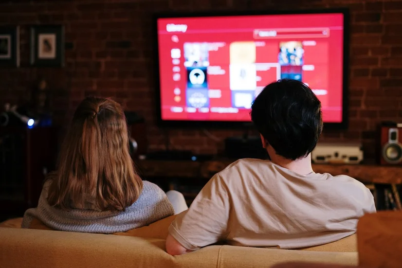 Couple watching a streaming service on TV