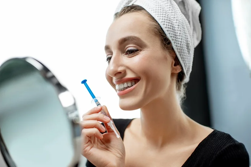 Woman happily using a home whitening kit