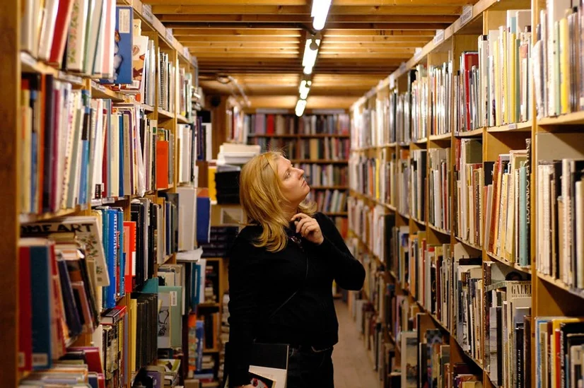 Woman browsing in large used bookshop