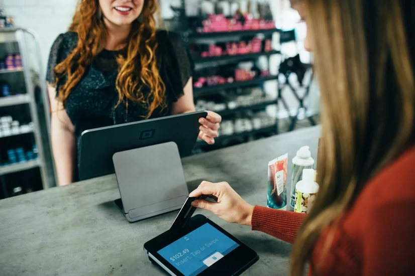 Woman shopping using a rewards card