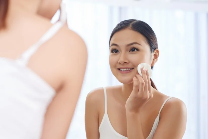 Woman using face toner