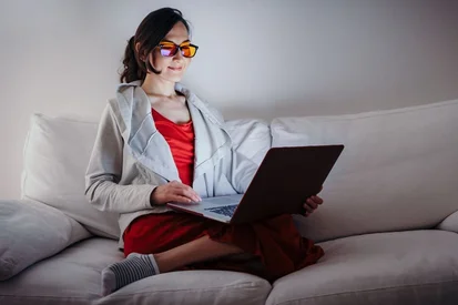 Woman wearing blue-light blocking glasses