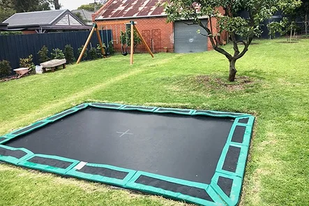 In-ground trampoline in backyard