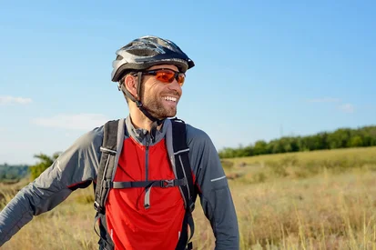 Man in cycliing attire wearing cycling glasses