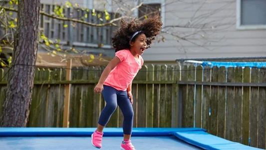 Girl jumping on trampoline