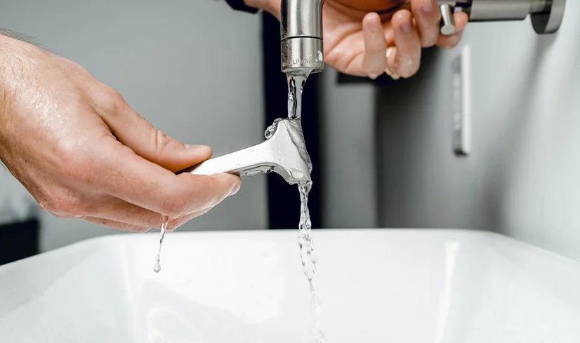 Safety razor being rinsed in tap water