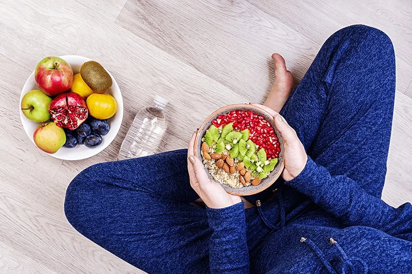 Women sitting down to a bowl of healthy fruit and oats