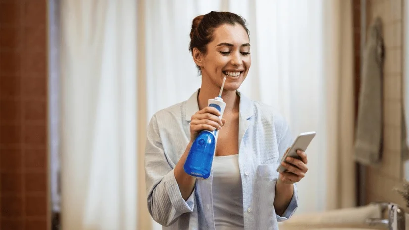Image of woman using a water flosser