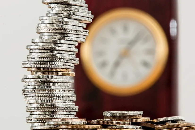 Piles of coins and a clock