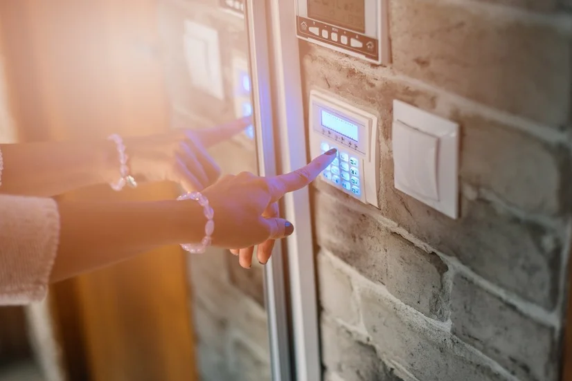 Woman's hand using a door keypad